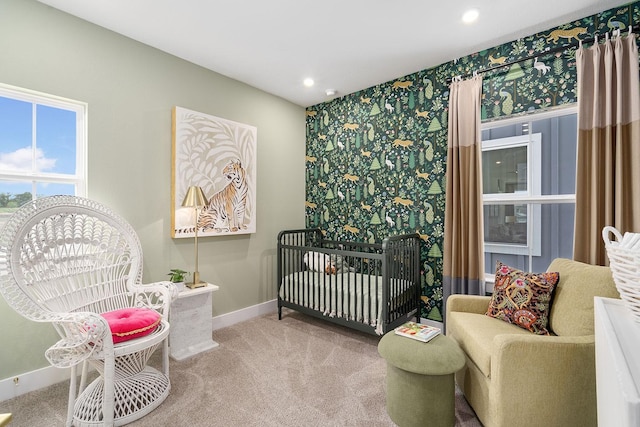 carpeted bedroom with a nursery area