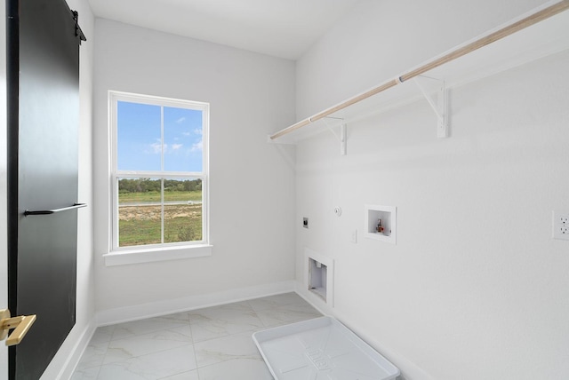 clothes washing area featuring hookup for a washing machine, hookup for a gas dryer, hookup for an electric dryer, and a barn door