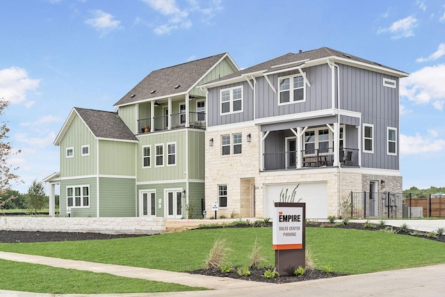 exterior space featuring a garage, a front yard, and a balcony