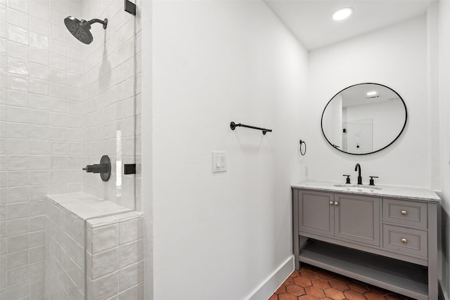 bathroom featuring tiled shower, tile patterned floors, and vanity