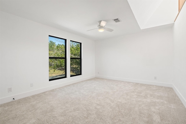 empty room with ceiling fan and carpet