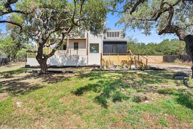 rear view of property with a yard