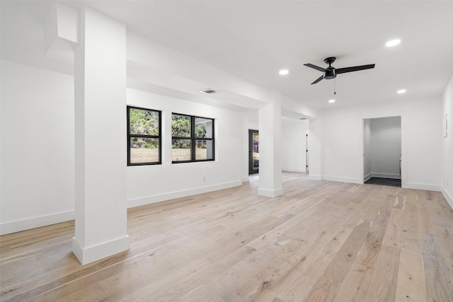 unfurnished living room featuring ceiling fan and light wood-type flooring