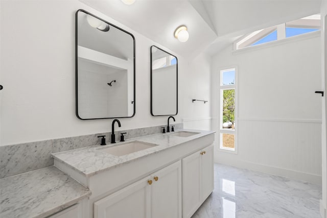 bathroom with vanity and vaulted ceiling