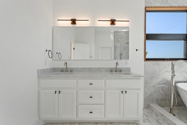 bathroom featuring independent shower and bath and vanity