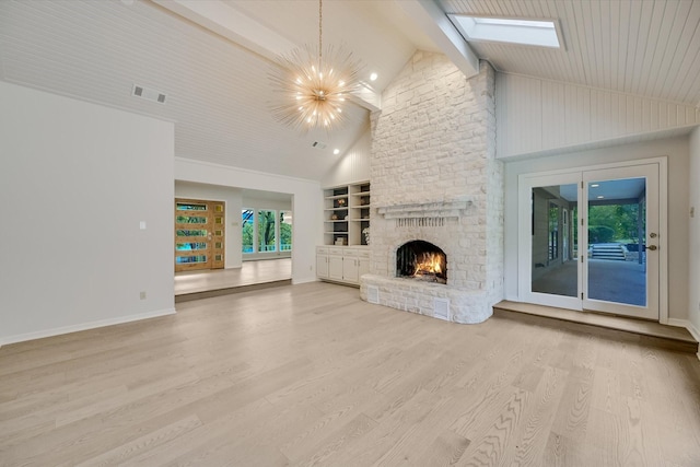 unfurnished living room featuring built in features, high vaulted ceiling, wood-type flooring, a chandelier, and a brick fireplace