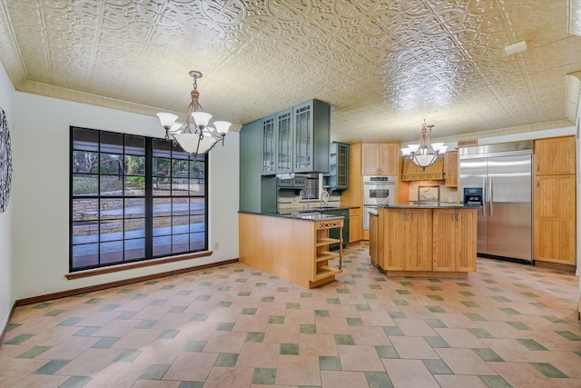 kitchen featuring an inviting chandelier, appliances with stainless steel finishes, and pendant lighting