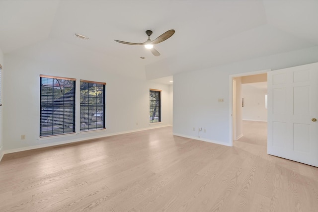 spare room featuring vaulted ceiling, light hardwood / wood-style floors, and ceiling fan