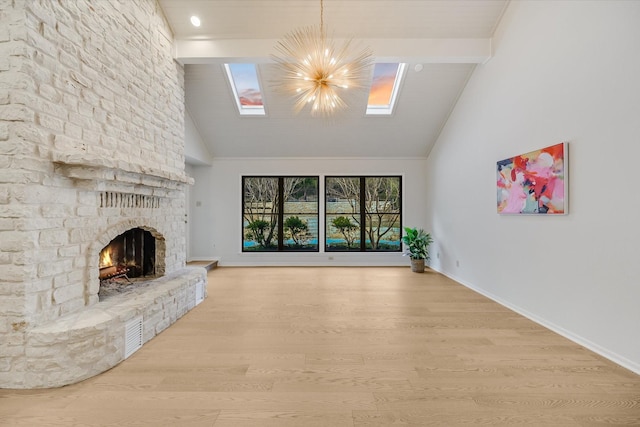 unfurnished living room with high vaulted ceiling, beamed ceiling, a stone fireplace, a chandelier, and light wood-type flooring