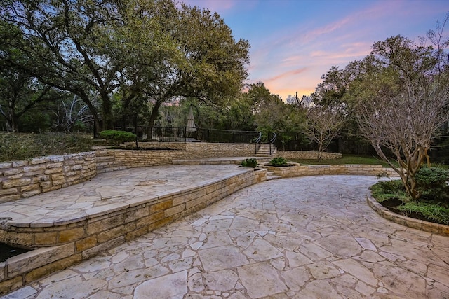 view of patio terrace at dusk