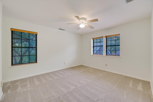 empty room featuring carpet floors and ceiling fan