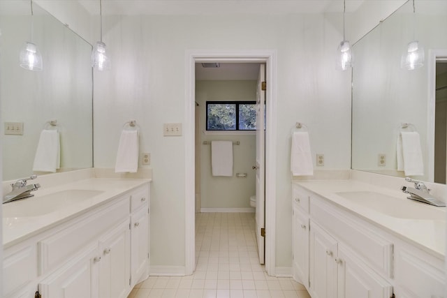 bathroom featuring tile patterned flooring, vanity, and toilet