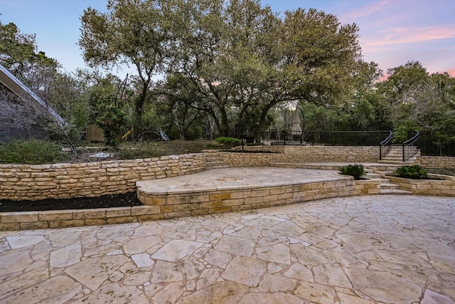 view of patio terrace at dusk