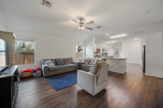 living room with vaulted ceiling, dark wood-type flooring, and ceiling fan