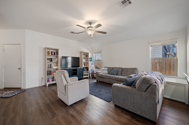 living room featuring ceiling fan and dark hardwood / wood-style flooring