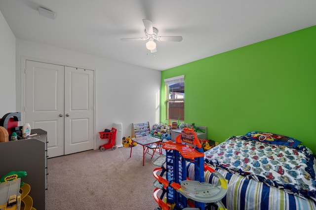 carpeted bedroom with a closet and ceiling fan