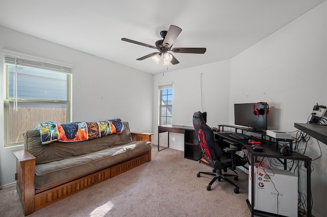 carpeted home office featuring ceiling fan