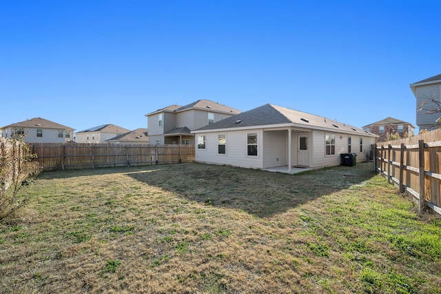 rear view of house featuring a yard