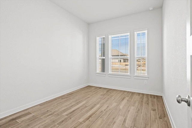 unfurnished room with light hardwood / wood-style flooring