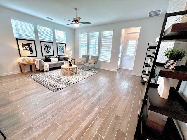 living room featuring ceiling fan and light hardwood / wood-style flooring