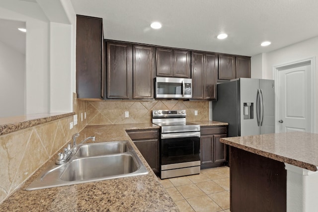 kitchen with sink, backsplash, dark brown cabinets, stainless steel appliances, and light tile patterned flooring