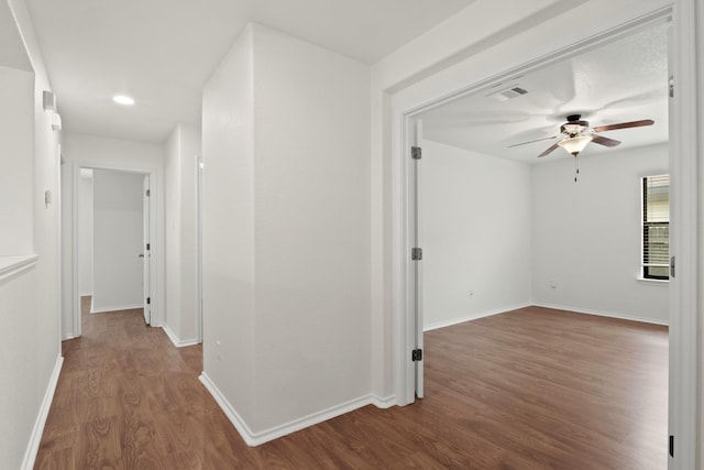 corridor with wood-type flooring