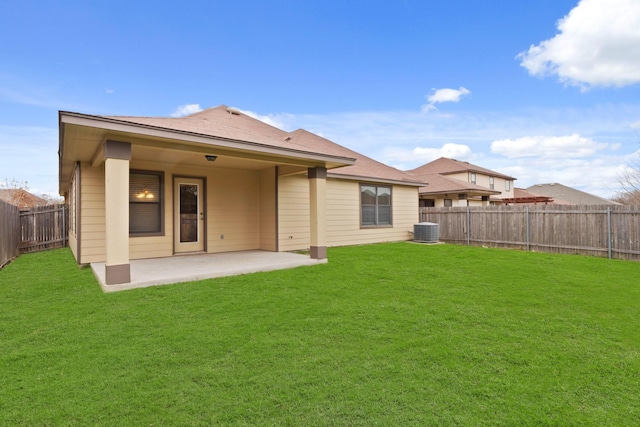 rear view of property with central AC, a yard, and a patio