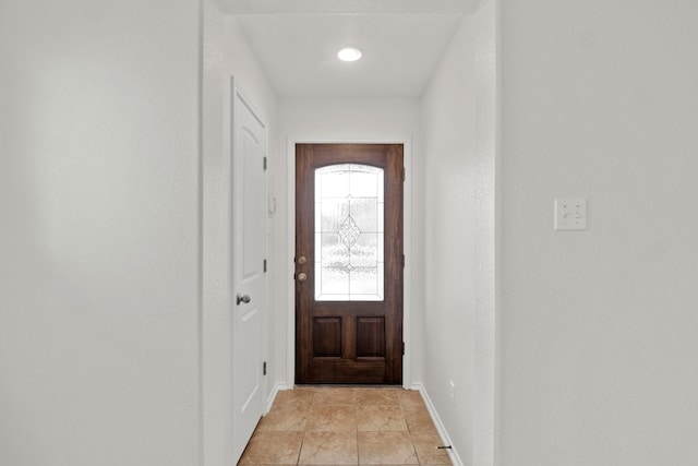 doorway to outside with light tile patterned floors