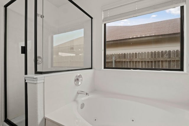 bathroom featuring a relaxing tiled tub