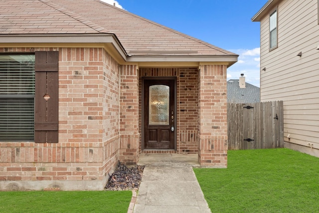 entrance to property with a yard