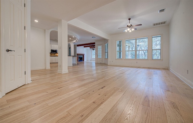 unfurnished living room with ceiling fan and light wood-type flooring