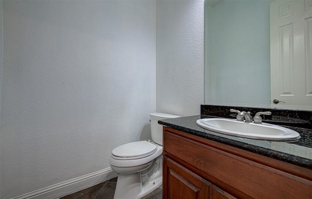 bathroom featuring tile patterned floors, toilet, and vanity