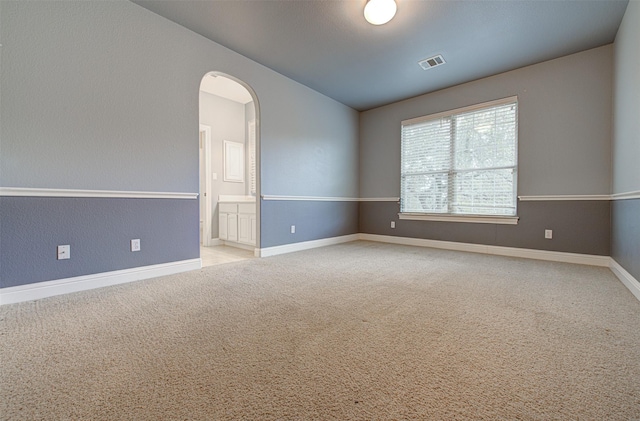 unfurnished room with light colored carpet