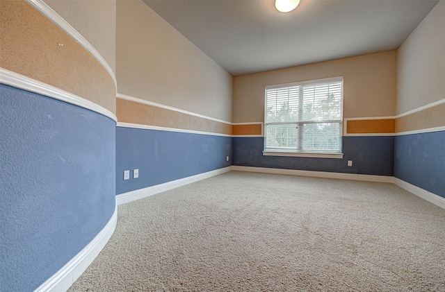 spare room with vaulted ceiling and carpet flooring