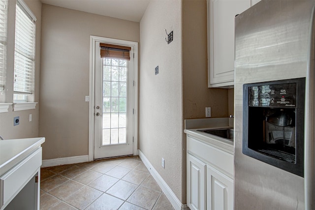 doorway featuring light tile patterned floors and a wealth of natural light