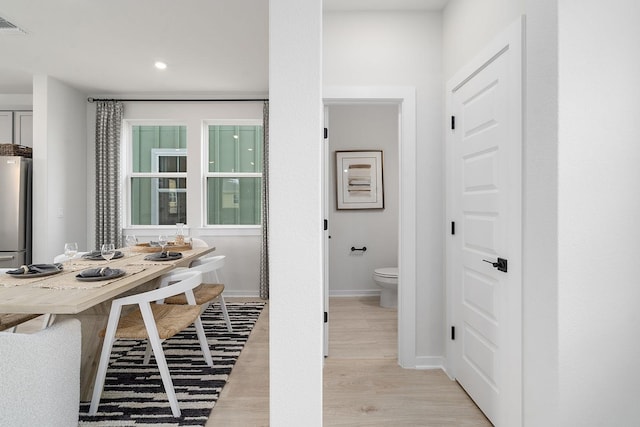 bathroom featuring hardwood / wood-style floors and toilet