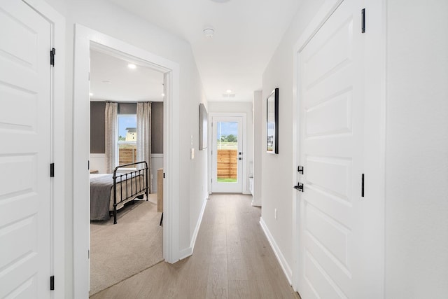 hall featuring plenty of natural light and light wood-type flooring