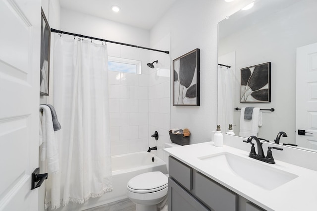 full bathroom with vanity, shower / tub combo with curtain, and toilet