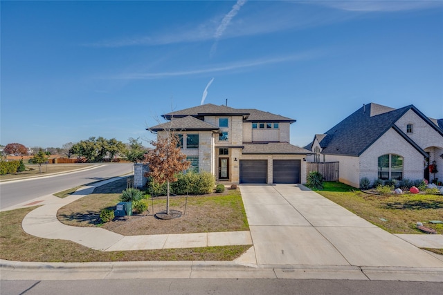 view of front of home featuring a garage and a front lawn