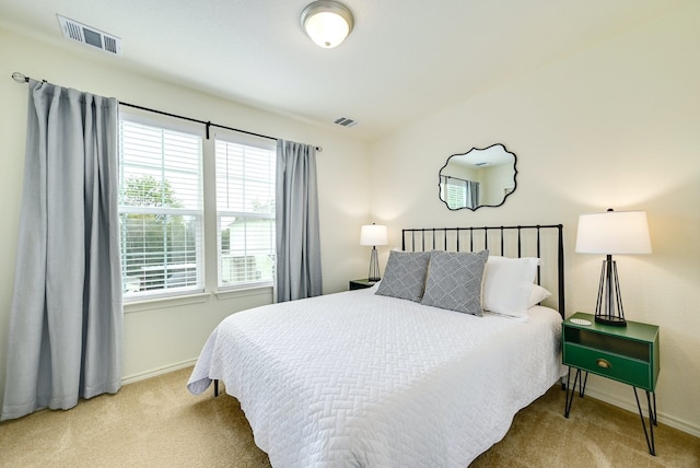 carpeted bedroom with multiple windows