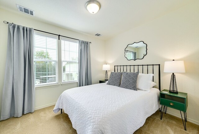 bedroom with visible vents, carpet floors, and baseboards