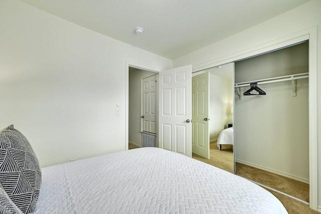 carpeted bedroom featuring a closet