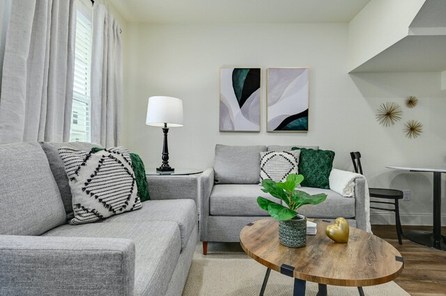 living area featuring wood finished floors and baseboards