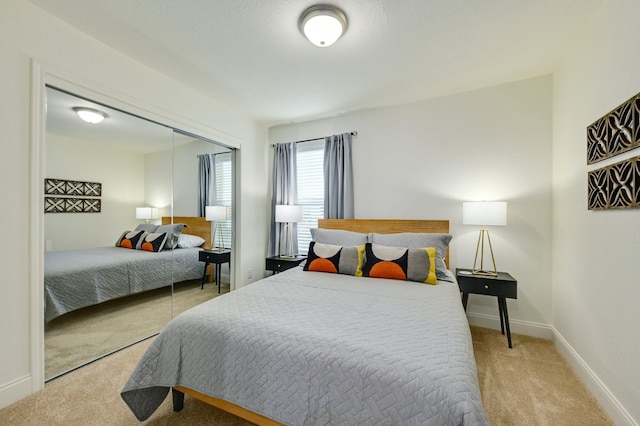 bedroom with light colored carpet and a closet