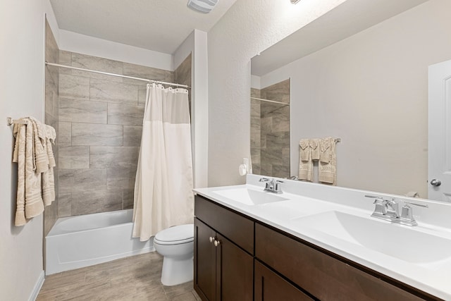 full bathroom featuring shower / tub combo with curtain, vanity, and toilet