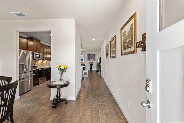 hall with hardwood / wood-style flooring