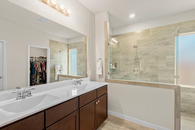 bathroom with tile patterned floors, vanity, and a shower with shower door