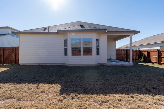 rear view of property with a lawn and a patio area