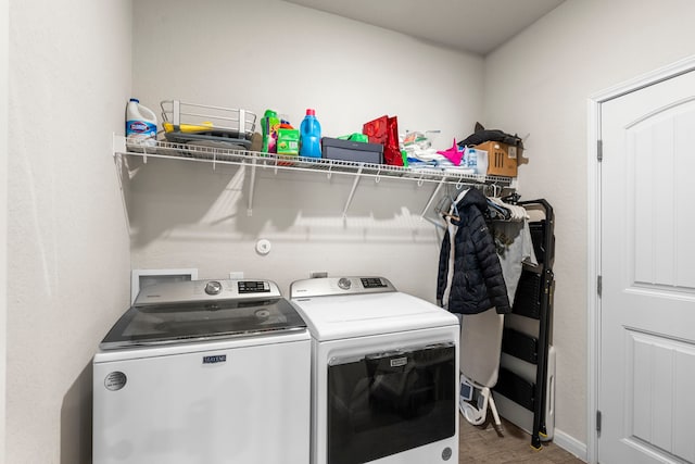 laundry room with light hardwood / wood-style floors and washer and dryer