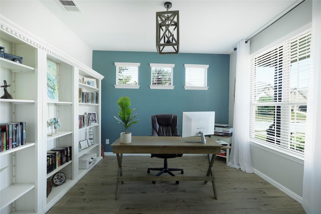 office space featuring wood-type flooring and built in features